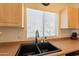 Well-lit kitchen sink features a double basin, sleek black faucet, and pleasant view at 7401 W Arrowhead Clubhouse Dr # 2003, Glendale, AZ 85308