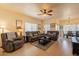 Warm living room featuring tile flooring, comfortable seating, and a ceiling fan with dining area access at 7401 W Arrowhead Clubhouse Dr # 2003, Glendale, AZ 85308