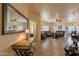 Warm, open-concept living room with comfortable seating, tile flooring, and plenty of natural light from several windows at 7401 W Arrowhead Clubhouse Dr # 2003, Glendale, AZ 85308