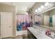 A vanity in the bathroom offers lots of counter space, bright lighting, and updated fixtures at 8445 N 61St Ln, Glendale, AZ 85302