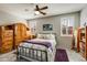 Comfortable bedroom featuring a ceiling fan, wood-look floors, and lots of natural light at 8445 N 61St Ln, Glendale, AZ 85302