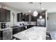 Modern kitchen featuring granite countertops, stainless steel appliances, and dark wood cabinets at 8445 N 61St Ln, Glendale, AZ 85302