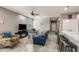 Cozy living room with comfortable seating, a ceiling fan, and seamless access to the kitchen at 8445 N 61St Ln, Glendale, AZ 85302