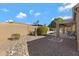 Spacious backyard with rock landscaping, walled for privacy, and covered patio by the pool at 8544 E Ocaso Ave, Mesa, AZ 85212