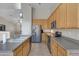 Functional kitchen with stainless steel appliances, light wood cabinetry and tiled floors at 8544 E Ocaso Ave, Mesa, AZ 85212