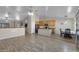 Open-concept living space featuring wood floors that connect the dining and kitchen areas at 8544 E Ocaso Ave, Mesa, AZ 85212