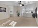 Spacious living room with ceiling fan, natural light, and seamless transition to other living areas at 8544 E Ocaso Ave, Mesa, AZ 85212