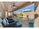 View of the pool from covered patio with ceiling fan and outdoor seating in landscaped backyard at 8544 E Ocaso Ave, Mesa, AZ 85212