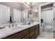 Bathroom featuring a double vanity with mirrors, white counters, and neutral wall color scheme at 8607 E Preserve Way, Scottsdale, AZ 85266