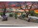 Desert home boasts mature landscaping, rock accents, and beautiful desert sunset at 8607 E Preserve Way, Scottsdale, AZ 85266