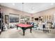 Spacious game room boasts a pool table, natural light, and ample space for crafting or hobbies at 8607 E Preserve Way, Scottsdale, AZ 85266