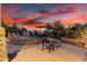 Outdoor living space on a tiered patio with wrought iron table set, and mature landscaping at 8607 E Preserve Way, Scottsdale, AZ 85266