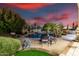 Inviting pool area with lush landscaping, patio seating, and an evening sunset view at 8607 E Preserve Way, Scottsdale, AZ 85266