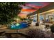 Inviting pool area with outdoor seating, a fire pit, and a covered patio, perfect for relaxation and entertaining at 8607 E Preserve Way, Scottsdale, AZ 85266