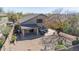 Aerial view displays backyard with covered patio and desert landscaping including rock accents at 10468 E Raintree Dr, Scottsdale, AZ 85255