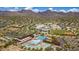 Wide aerial of community showing aquatic center, baseball field, surrounding homes and mountain views at 10468 E Raintree Dr, Scottsdale, AZ 85255