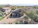 Aerial view showcases the backyard with a covered patio and desert landscaping at 10468 E Raintree Dr, Scottsdale, AZ 85255