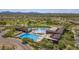 Aerial view of the community aquatic center featuring pools, green space and mountain views at 10468 E Raintree Dr, Scottsdale, AZ 85255