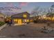 Back exterior of home with covered patio and a spacious xeriscaped backyard at 10468 E Raintree Dr, Scottsdale, AZ 85255