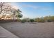 Spacious backyard with xeriscaping, natural rocks, and desert views at 10468 E Raintree Dr, Scottsdale, AZ 85255