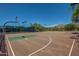 Expansive outdoor basketball court with multiple hoops, green accents, and scenic mountain views at 10468 E Raintree Dr, Scottsdale, AZ 85255