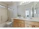 Bathroom with double sinks, a shower-tub combo, and ample lighting at 10468 E Raintree Dr, Scottsdale, AZ 85255