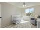 Bedroom with a crib, area rug, a large window, and neutral colors at 10468 E Raintree Dr, Scottsdale, AZ 85255