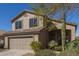 Charming two-story home featuring a two-car garage and desert landscaping on a sunny day at 10468 E Raintree Dr, Scottsdale, AZ 85255
