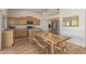 Well-lit kitchen with stainless steel appliances, light wood cabinets, and wood floors at 10468 E Raintree Dr, Scottsdale, AZ 85255