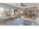 Open-concept living room with a gray sectional and views of the kitchen and backyard at 10468 E Raintree Dr, Scottsdale, AZ 85255