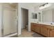 Bathroom featuring a walk-in shower, double vanity, and ample cabinet space at 10468 E Raintree Dr, Scottsdale, AZ 85255