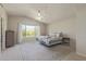 Bright main bedroom with a large window offering scenic mountain views and a ceiling fan at 10468 E Raintree Dr, Scottsdale, AZ 85255