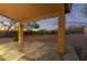 A covered patio with textured concrete and beautiful sunset backyard views at 10468 E Raintree Dr, Scottsdale, AZ 85255