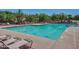 Community pool featuring lounge chairs, clear water, and poolside relaxation at 10468 E Raintree Dr, Scottsdale, AZ 85255