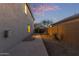 View of the side yard with desert landscaping and a walkway to the backyard gate at 10468 E Raintree Dr, Scottsdale, AZ 85255