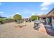 Spacious backyard featuring decorative rock, a gazebo, a barbecue and mature trees at 10842 W Sarabande Cir, Sun City, AZ 85351