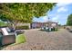 Backyard showcasing a gazebo, seating area, a mature citrus tree and low maintenance rock landscape at 10842 W Sarabande Cir, Sun City, AZ 85351