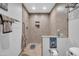 Walk-in shower with tiled walls and recessed shelf in the bathroom at 10842 W Sarabande Cir, Sun City, AZ 85351