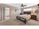 Comfortable bedroom with a ceiling fan and connecting closet at 10842 W Sarabande Cir, Sun City, AZ 85351