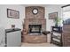 Corner brick fireplace with decorative items and mounted clock at 10842 W Sarabande Cir, Sun City, AZ 85351