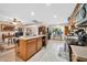 Large kitchen with island, wood cabinets, breakfast bar and adjacent dining area at 10842 W Sarabande Cir, Sun City, AZ 85351