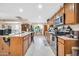 Modern kitchen boasts a large island, tiled floors, and stainless steel appliances at 10842 W Sarabande Cir, Sun City, AZ 85351