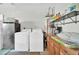 Well-lit laundry area with washer, dryer, and storage at 10842 W Sarabande Cir, Sun City, AZ 85351