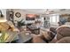 Comfortable living room with large screen TV, ceiling fan, and neutral wall color at 10842 W Sarabande Cir, Sun City, AZ 85351
