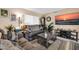 Cozy living room boasts a large-screen TV, a comfortable sofa, and neutral tones at 10842 W Sarabande Cir, Sun City, AZ 85351