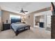 Comfortable bedroom suite with ceiling fan and open bathroom at 10842 W Sarabande Cir, Sun City, AZ 85351