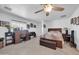 Spacious bedroom with tile floors, ceiling fan and large windows at 10842 W Sarabande Cir, Sun City, AZ 85351