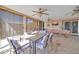 Inviting covered patio with a large dining table, ceiling fans, and outdoor seating area at 10842 W Sarabande Cir, Sun City, AZ 85351