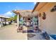 Covered patio with decorative iron archway and view of backyard landscaping and gazebo at 10842 W Sarabande Cir, Sun City, AZ 85351