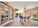 Covered patio features a tile floor, seating and view of the landscaped backyard at 10842 W Sarabande Cir, Sun City, AZ 85351